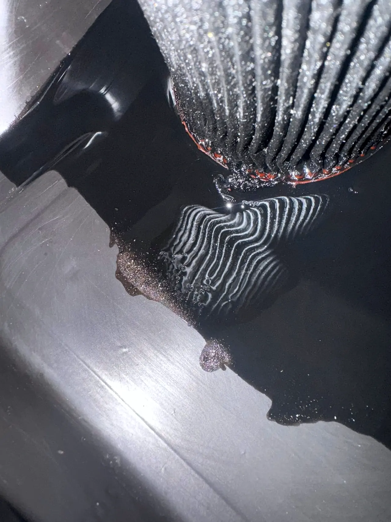 Borescope image showing metal debris inside a diesel engine
