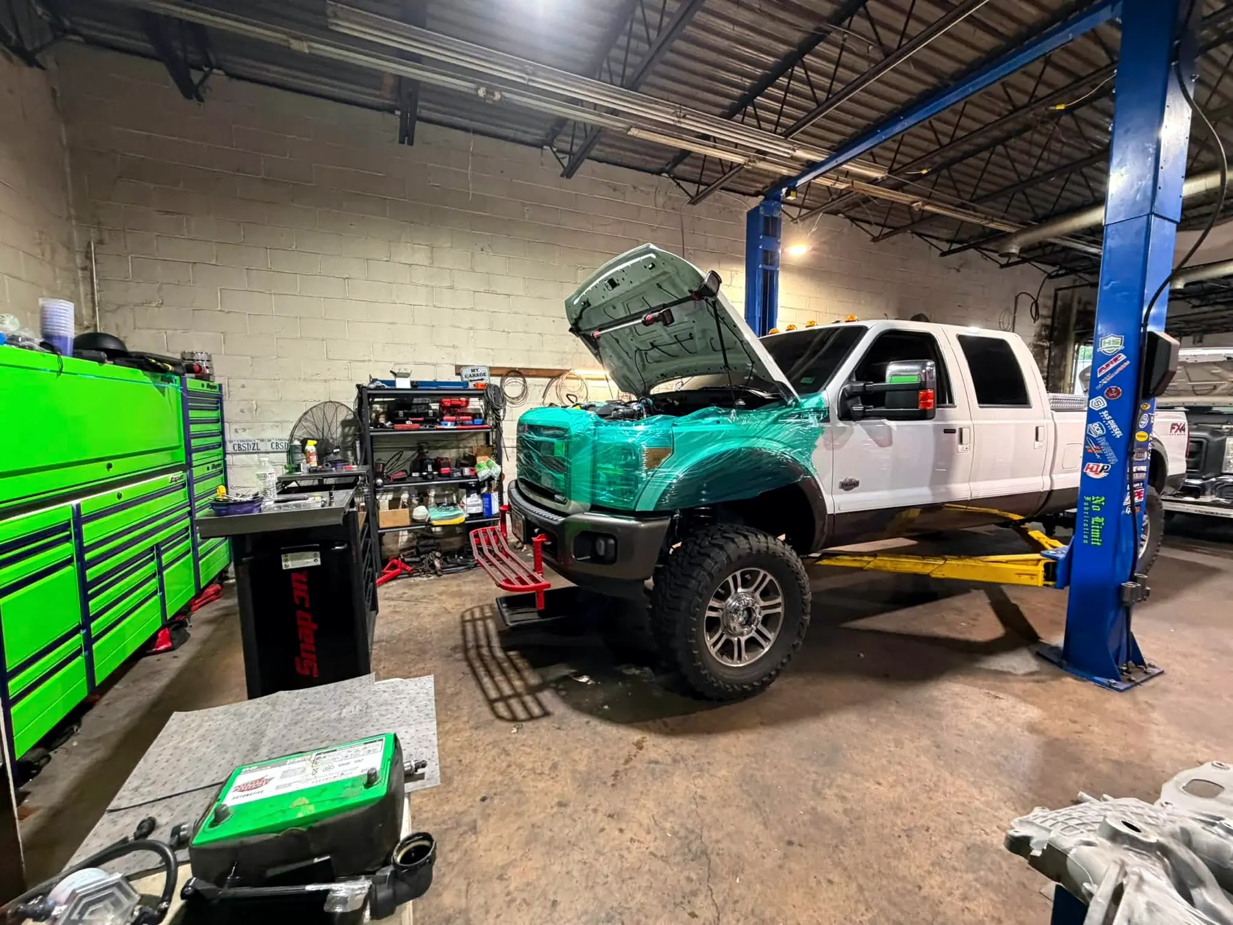 Lifted Ford F-350 in the bay at CBS Diesel