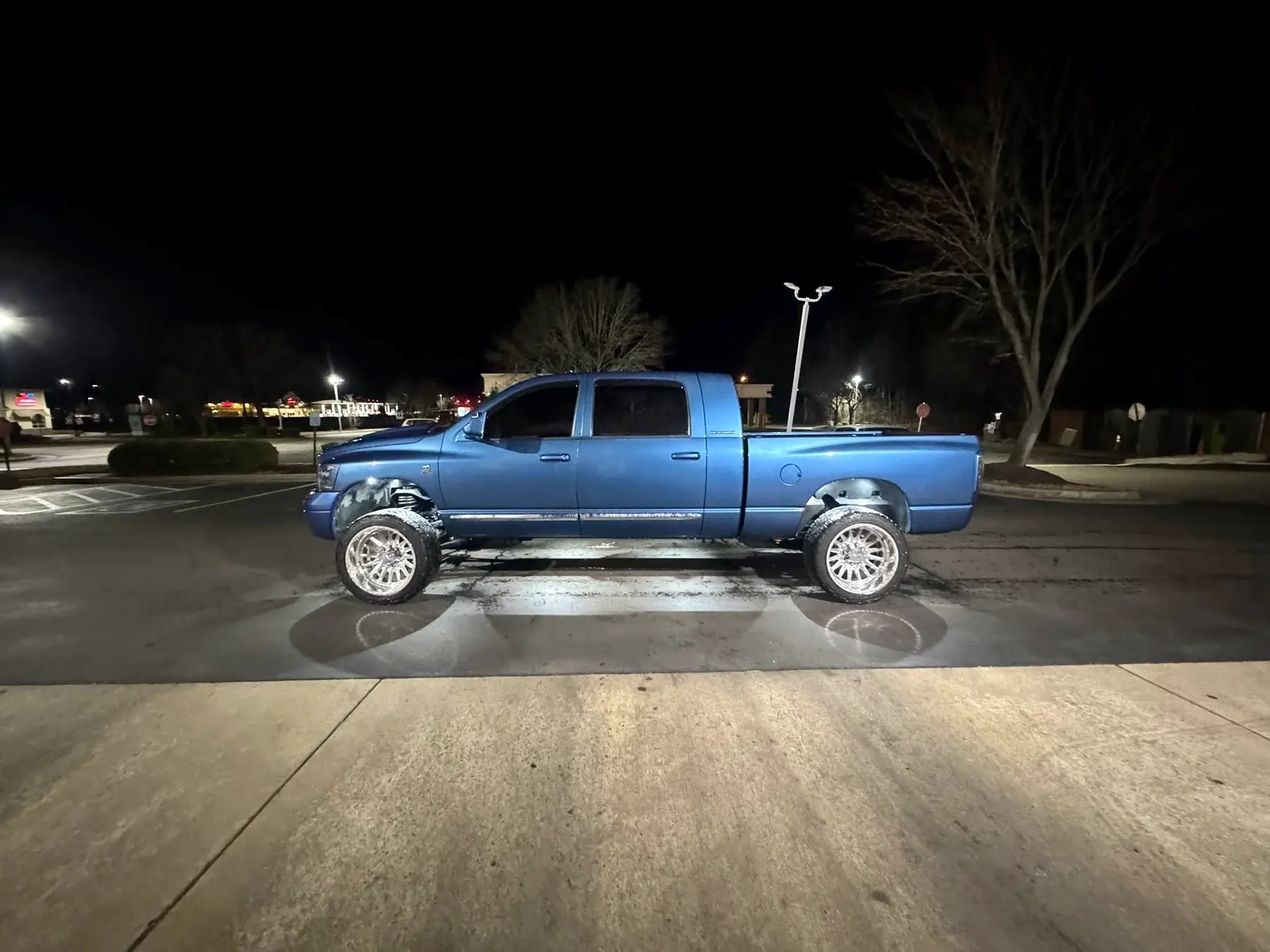 Blue Ram on polished aftermarket wheels photographed at night